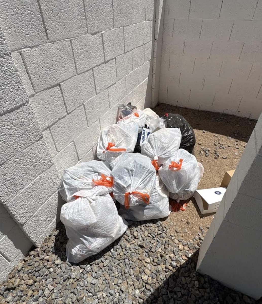 Bags stacked in courtyard corner