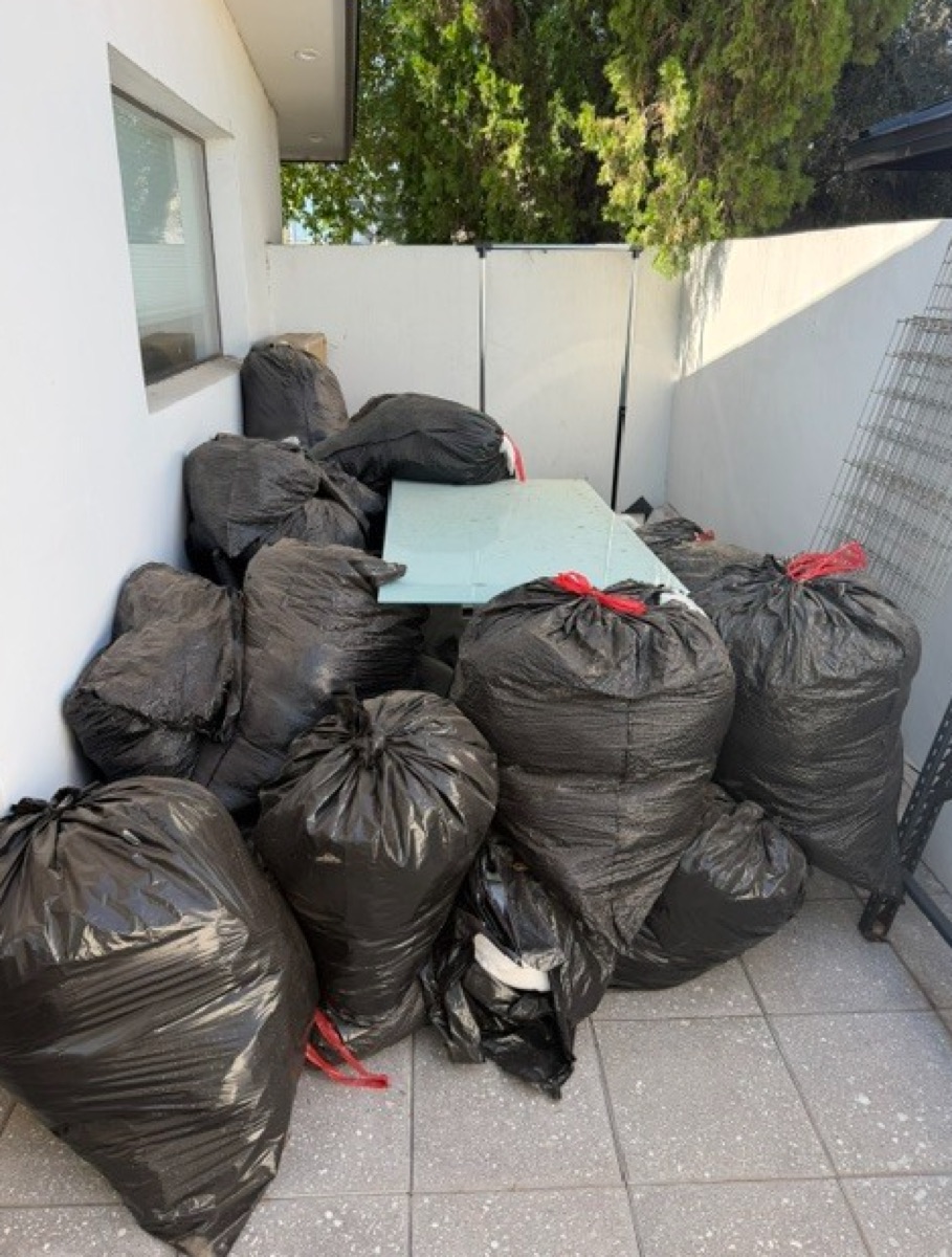 Trash bags piled on a patio